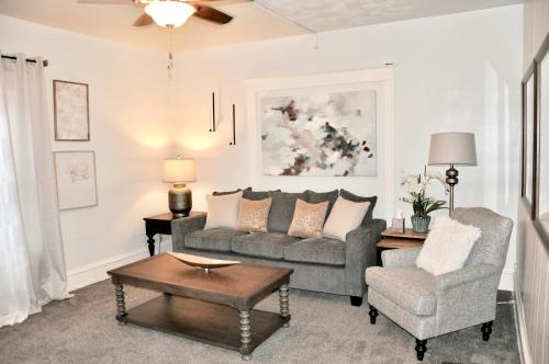 a living room with a couch and a chair at Downtown 1 Bedroom Charmer - Walk, Bike, Enjoy!! in Rapid City