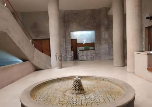 a room with a fountain in the middle of a building at Lux City Loft in front of the Port in Alicante