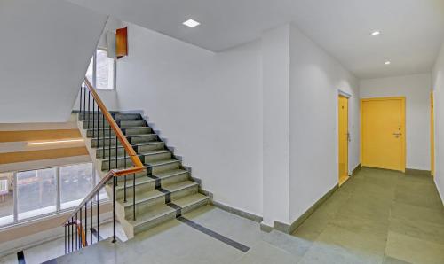 a staircase in a building with a yellow door at Raj Darbar - 10 Meter From Golden Temple in Amritsar