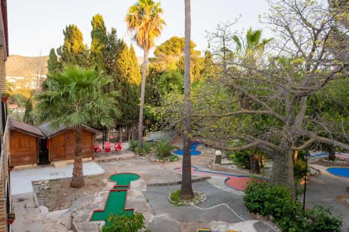 a park with a playground with trees and palm trees at APARTAMENTOS PALASIET in Benidorm