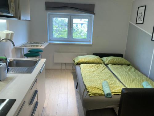 a small room with a bed in a kitchen at Roland Apartment - PUSKAS in Budapest