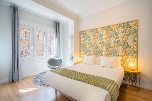 a bedroom with a bed and a painting on the wall at Barcelona Eixample in Barcelona