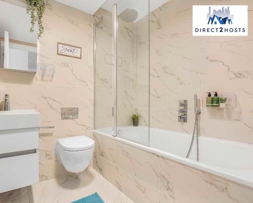 a bathroom with a tub and a toilet and a sink at Stylish Two Bedroom Apartments by Direct2hosts Short Lets West London Oasis With Workspace & Long Stays in London