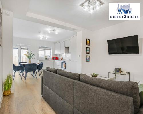 a living room with a couch and a table at Stylish Two Bedroom Apartments by Direct2hosts Short Lets West London Oasis With Workspace & Long Stays in London