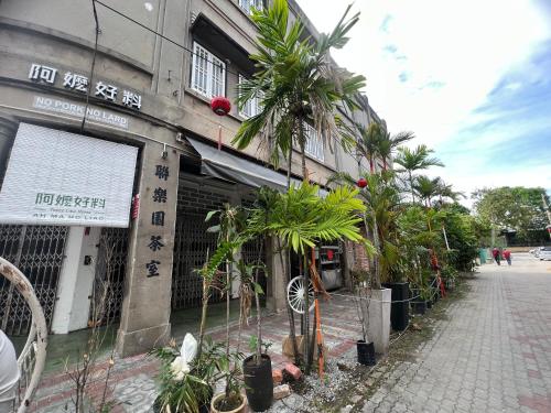 a building with palm trees in front of it at New! 1min to JonkerStreet TangHouse's Hotel Melaka 鸡场街 in Melaka