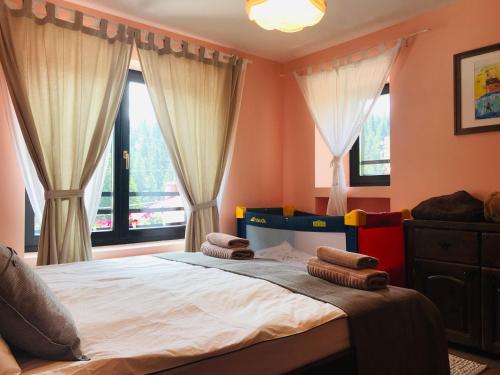 a bedroom with a bed with two pillows on it at Kutsinska House in Progled