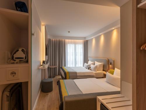 a hotel room with two beds and a fireplace at Holiday Inn Express Munich - City East, an IHG Hotel in Munich