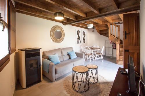 a living room with a couch and a table at Madre Rosa I, casa rural con la playa a 12 km in Llanes