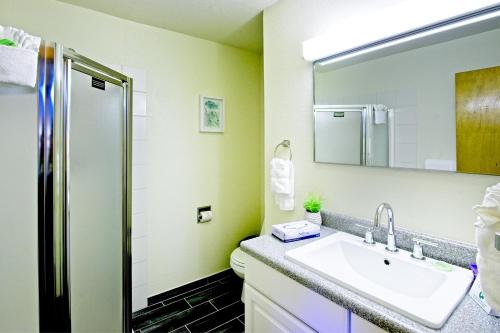 a bathroom with a sink and a mirror at Sitzmark Sports Lodge in Red River