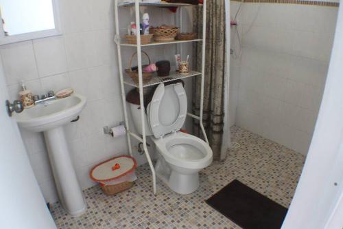 a bathroom with a toilet and a sink at House at Centro Histórico with pool in Mérida