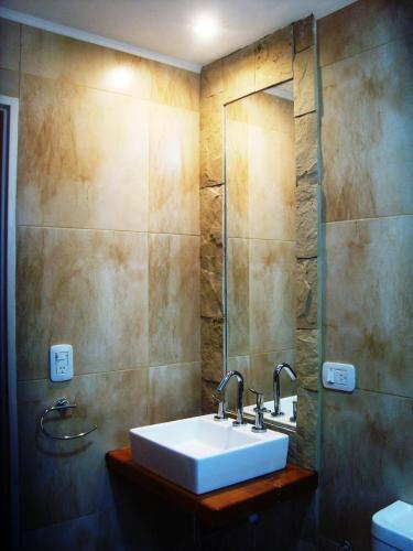a bathroom with a sink and a mirror at Miralagos Apart & Cabañas in Villa Pehuenia