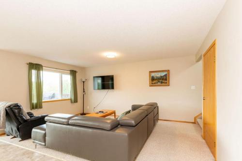 a living room with a couch and a tv at Waterton Country Villas in Waterton Park