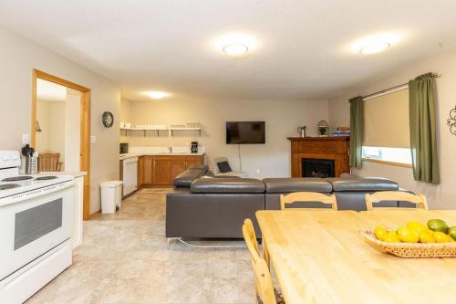 a living room with a couch and a table at Waterton Country Villas in Waterton Park