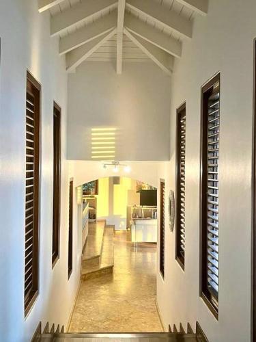 a hallway of a house with a living room at VillaDelSol-Ocean Front Resort-Pool-up to 8 Guests-Walk to the Beach in Willibrordus