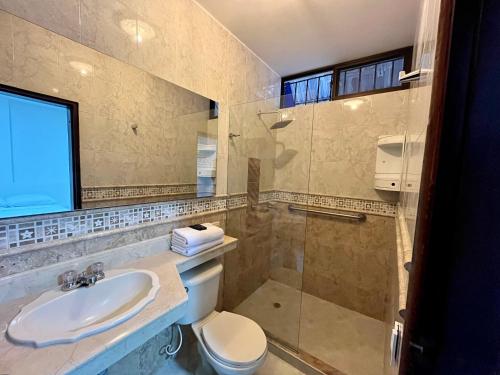 a bathroom with a sink and a toilet and a shower at Hostal Boutique Casa Pere in Cartagena de Indias