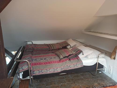 a small bed in a small room with a bedspread at Cozy Panorama at the Castle in Budapest