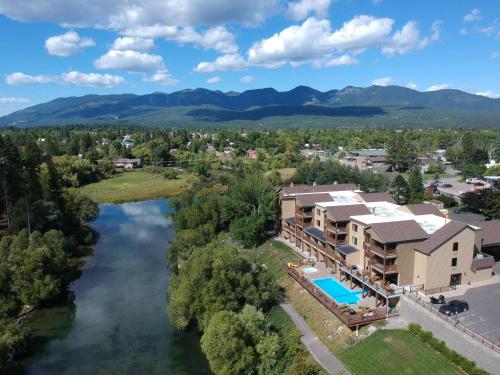 an aerial view of a resort with a river at Whitefish Riverfront Hotel in Whitefish