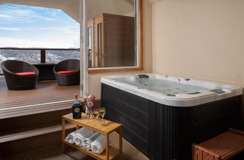 a large bath tub in a room with a balcony at Hermann Hill in Hermann