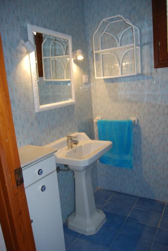 a bathroom with a sink and a mirror at Villa Maria Beach Villa in Moraira