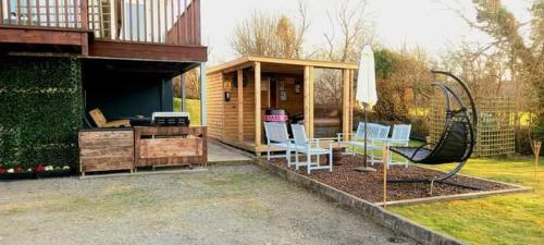 ein Haus mit einer Terrasse mit Stühlen und einem Haus in der Unterkunft Bundoran seclusion in Bundoran