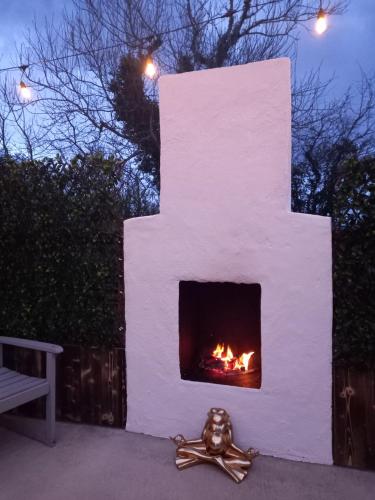 a fireplace with a fire in it at night at Bundoran seclusion in Bundoran