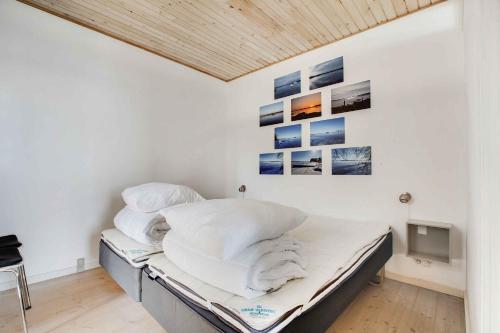 a bed in a room with pictures on the wall at Holiday Home With Private Beach And Fantastic View in Kolding