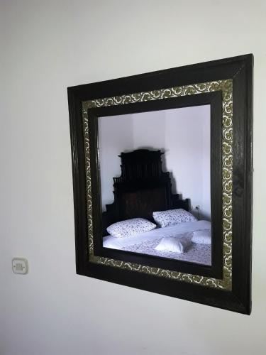 a mirror on a wall with a bed in it at Agroturizam Duvančić - Konoba dida Marka in Drniš