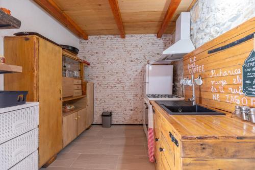 a kitchen with wooden cabinets and a counter top at Murva in Posedarje