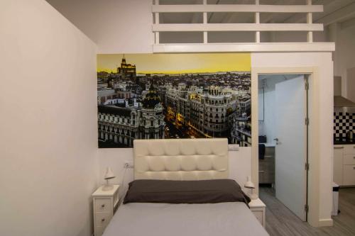 a bedroom with a large poster of a city at Loft madrid in León