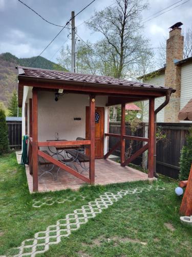 a gazebo with a table on a patio at Casa Mi&Ra in Lepşa