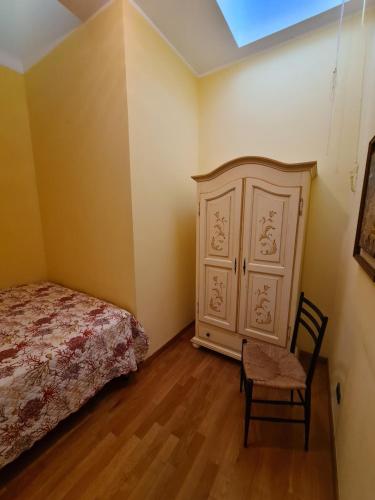 a bedroom with a bed and a dresser and a chair at Grande Attico con Vista Vicino al Centro by PortofinoVacanze in Rapallo