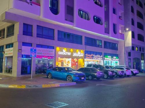 a group of cars parked in front of a building at Affordable transient - not a hotel - sharing kitchen and washrooms in Abu Dhabi