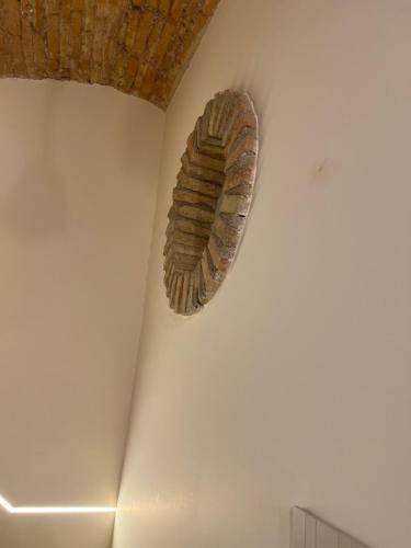 a artifact hanging on the wall of a room at Le Dimore Del Gufo - Royal Suite in Venosa