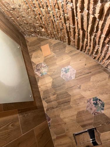 a staircase with a wooden floor and a stair case at Le Dimore Del Gufo - Royal Suite in Venosa