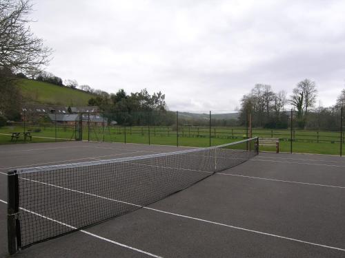 a tennis court with a net on it at Duddings Country Cottages in Minehead