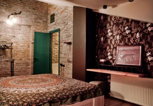 a bedroom with a bed and a green door at Magic Attic in Historical House in Tbilisi City