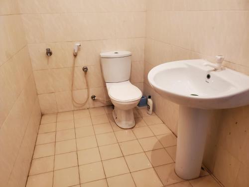 a bathroom with a toilet and a sink at Mount lavinia home in Watumulla