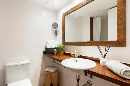 a bathroom with a sink and a mirror at Columbus Apartment in Barcelona