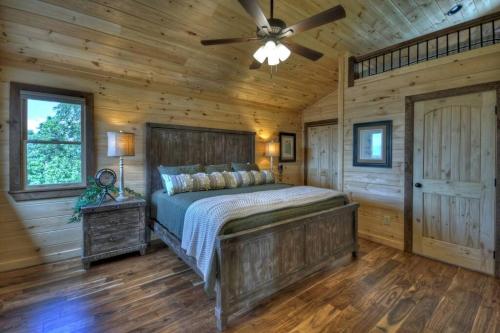 a bedroom with a bed and a ceiling fan at Sunset Ridge w Stunning 5 Star Views & Hot Tub in Blue Ridge