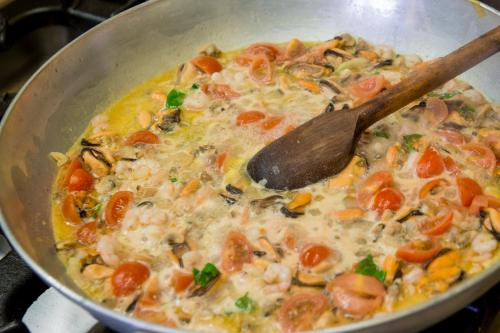 a pot of soup with a wooden spoon in it at Agriturismo Tarantola in Alcamo