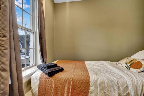 a bedroom with a bed and a window at Chair Lift Lodge- Best Location in EVL Village! in Ellicottville