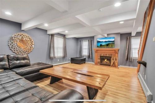 a living room with a couch and a table at Chair Lift Lodge- Best Location in EVL Village! in Ellicottville
