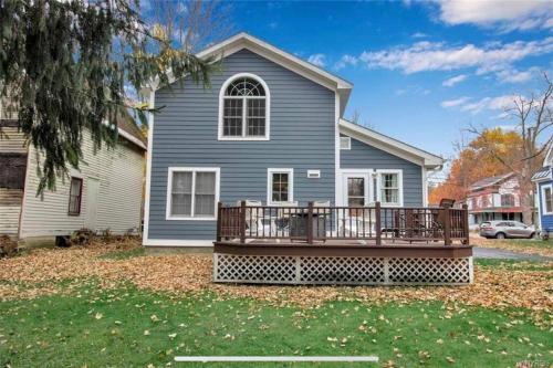 a house with a large deck in front of it at Chair Lift Lodge- Best Location in EVL Village! in Ellicottville