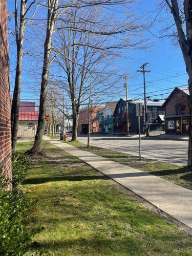 a sidewalk in a town with trees and a street at Chair Lift Lodge- Best Location in EVL Village! in Ellicottville