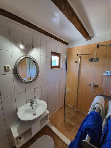 a bathroom with a sink and a shower at Agroturizam Duvančić - Konoba dida Marka in Drniš