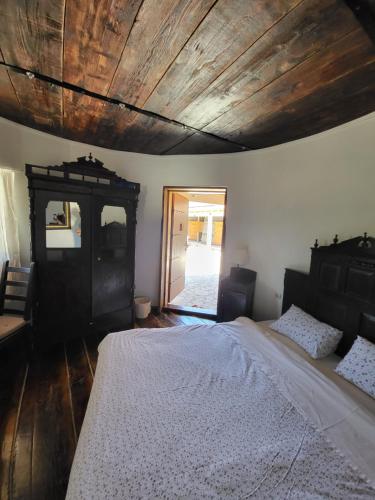 a bedroom with a bed and a wooden ceiling at Agroturizam Duvančić - Konoba dida Marka in Drniš