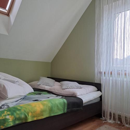 a bedroom with two beds and a window at Domki Oaza Spokoju Berezka in Berezka