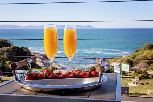 a tray of strawberries and two champagne glasses on a table at 7 on Marine in Hermanus