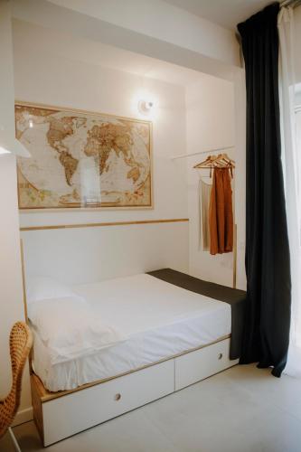 a bedroom with a bed with a map on the wall at Casa GINA a 2 passi dal mare in Terracina