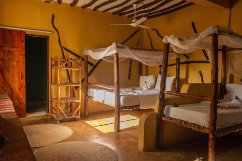 a bedroom with two bunk beds in a room at PASHA HOTEL Zanzibar in Nungwi